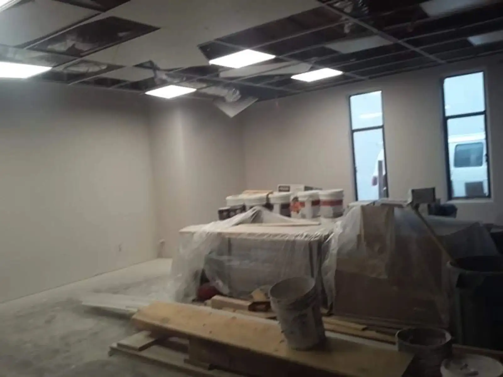 Commercial interior with protected millwork and construction debris prior to final clean