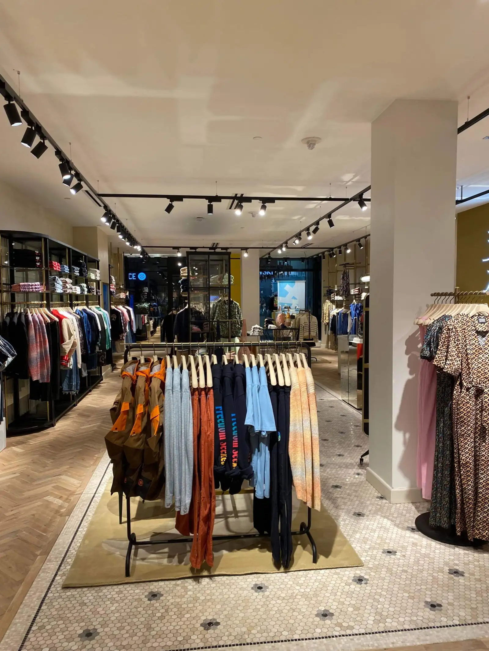 Clean apparel display racks and walkways on a retail sales floor