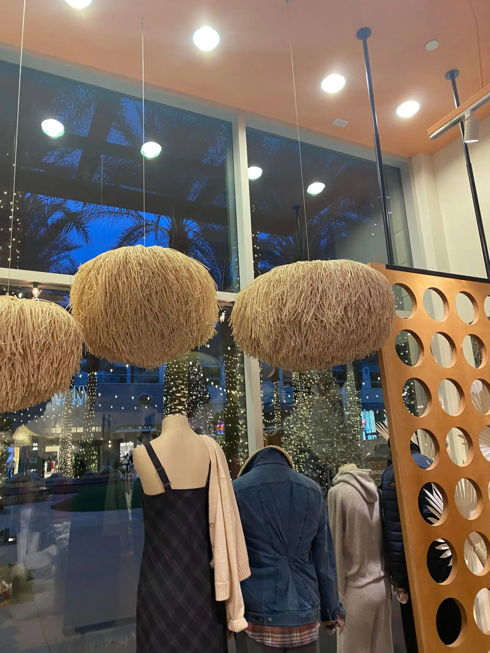 Retail interior with woven pendant lighting and clean display surfaces