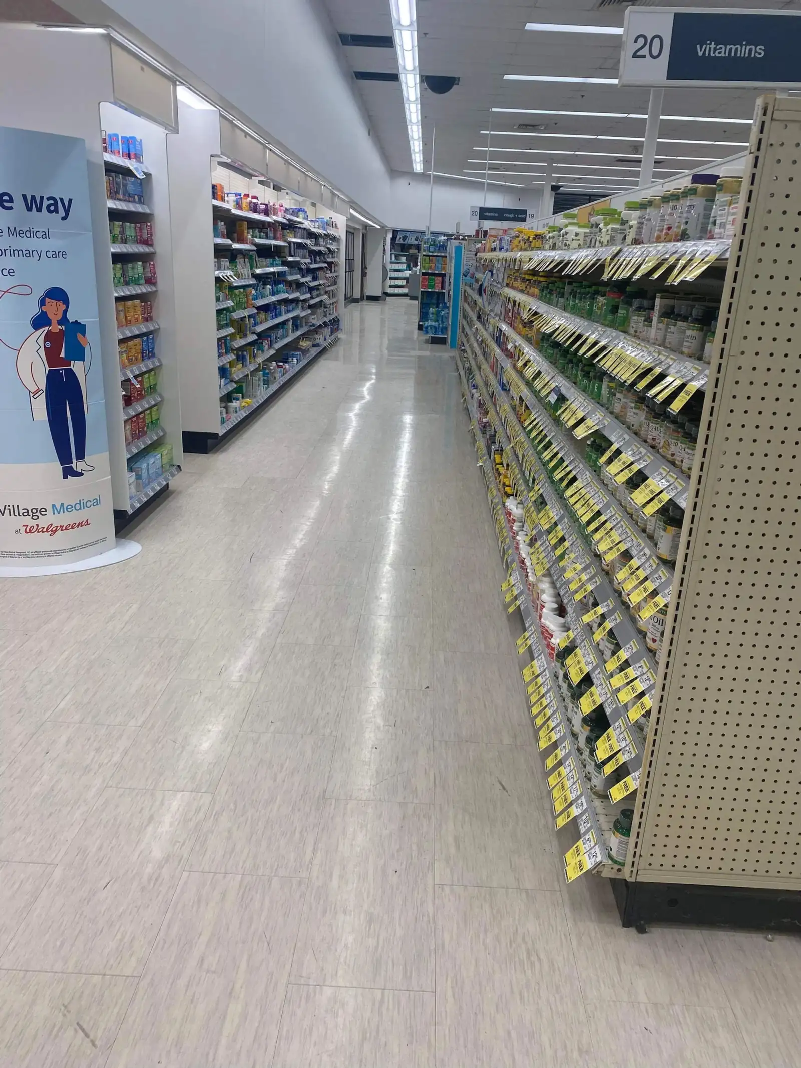 Retail pharmacy aisle with stocked shelving and clean flooring
